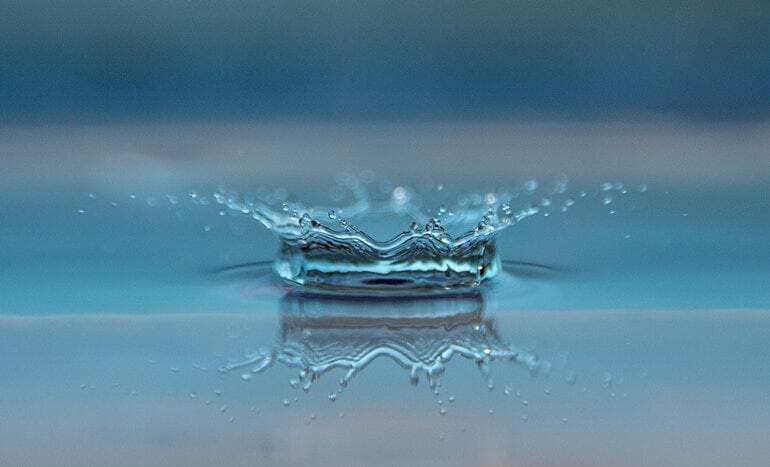 water drop into puddle