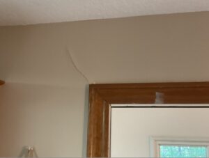 crack in drywall above door frame