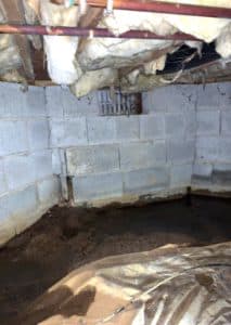 wet crawl space with damage vapor barrier