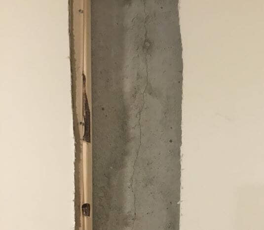 Thin crack in a poured concrete wall.