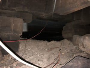 crawl space with crumbling support columns
