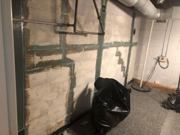basement wall repaired with straps