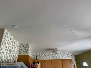 Cracked kitchen ceiling caused by foundation settling.