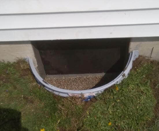 Window well and crawl space door after installation.