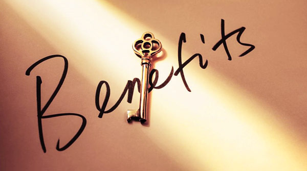 A brass key overlaying the handwritten word "Benefits"